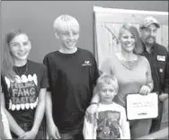  ?? Broken Bow Chamber of Commerce ?? Andy Gibbons of Ansley, far right, is donating a kidney to 16-year-old Jacob Hoblyn-Bittner. Gibbons is pictured with his family at the ribbon cutting for his wife’s business, Gibbon’s Gadgets. From left are Addy, Joey and Riley and wife Cassandra.