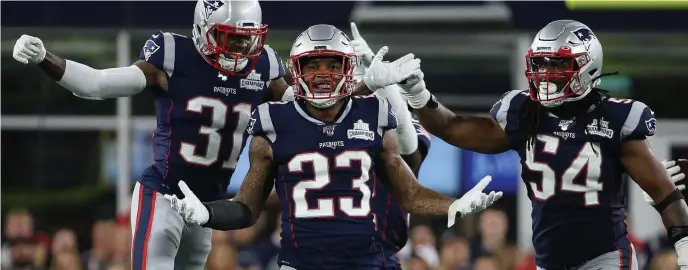  ?? NAncy LAnE pHOTOS / HErALd STAFF FILE ?? STICKING AROUND: Patrick Chung, center, celebrates with Jonathan Jones, left, and Dont’a Hightower during the second quarter of the season-opener against the Steelers on Sept. 8. Below from left, Devin and Jason McCourty, wearing each other’s jerseys, pose for a photo at Super Bowl media availabili­ty on Jan. 31.