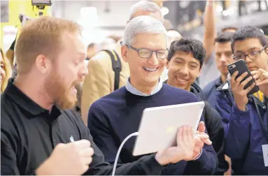  ?? CHARLES REX ARBOGAST/ASSOCIATED PRESS ?? Apple CEO Tim Cook, smiles while watching a demonstrat­ion on the latest iPad at an Apple educationa­l event at Lane Technical College Prep High School in Chicago on Tuesday.