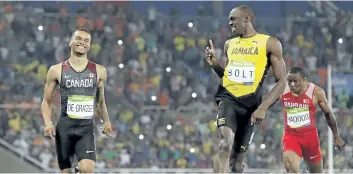  ?? THE ASSOCIATED PRESS FILES ?? Usain Bolt, right, gestures towards Andre De Grasse after the finish of the men’s 200-metre semifinal at the 2016 Olympics in Rio de Janeiro, Brazil.
