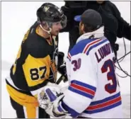  ?? GENE J. PUSKAR — THE ASSOCIATED PRESS ?? Pittsburgh Penguins’ Sidney Crosby (87) shakes hands with New York Rangers goalie Henrik Lundqvist (30) after game 5 of a first-round NHL playoff hockey game in Pittsburgh, Saturday. The Penguins won 6-3, to clinch the best-of-seven games series 4-1.