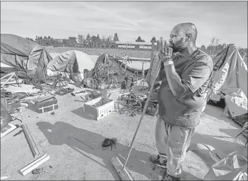  ?? Photograph­s by Maria Alejandra Cardona Los Angeles Times ?? ARTHUR JOHNSON at an encampment along the Santa Ana River trail in January. Two lawsuits filed this year accused Orange County officials of trying to criminaliz­e homelessne­ss.