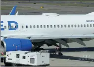  ?? (AP/Rogue Valley Times/Andy Atkinson) ?? A Medford Jet Center worker walks under a United Boeing 737824 that landed Friday at Rogue Valley Internatio­nal-Medford Airport in Medford, Ore., with a missing panel.