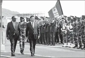  ?? AP/XAUME OLLEROS ?? President Macky Sall (left) of Senegal and Chinese counterpar­t Xi Jinping inspect the honor guard Saturday as Xi makes a state visit to Senegal’s capital, Dakar.