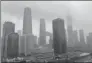  ?? SHEN GANG / FOR CHINA DAILY ?? Buildings in Beijing’s Guomao area are enshrouded by rain clouds on Thursday afternoon.