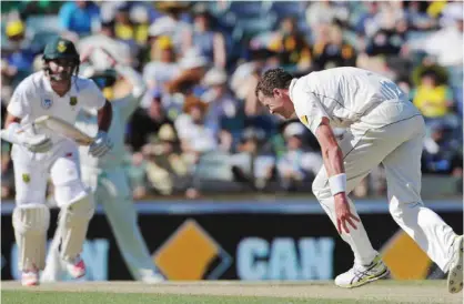  ??  ?? PERTH: Australian bowler Peter Siddle (R) grimaces as he attempts to stop a shot from South Africa’s Dean Elgar (L) on day three of the first Test cricket match between Australia and South Africa in Perth yesterday. — AFP