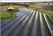  ?? JULIO CORTEZ — THE ASSOCIATED PRESS FILE ?? Farmland is seen with solar panels from Cypress Creek Renewables in Thurmont, Md.