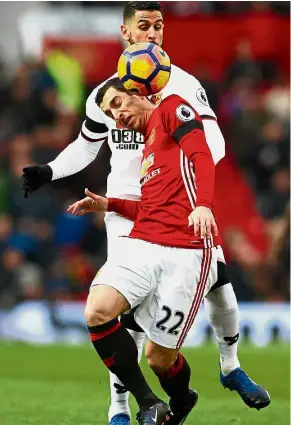  ?? — Reuters ?? Stuck on you: Manchester United’s Henrikh Mkhitaryan controllin­g the ball as Watford’s Miguel Britos closes in during the English Premier League match at Old Trafford yesterday.