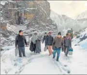  ?? PTI ?? EC officials with EVMs on their way to polling stations in Himachal Pradesh’s Lahaul and Spiti district on Thursday.