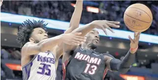  ?? LYNNE SLADKY/AP ?? Heat center Bam Adebayo battles for possession of a rebound Monday against the Kings’ Marvin Bagley III.