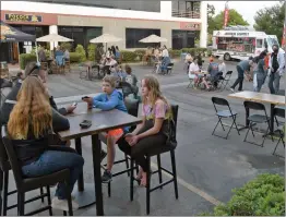  ??  ?? Dozens of customers sit outside, in the parking lot during Pocock Brewing Company’s reopening in Valencia. PHOTO BY DAN WATSON / THE SIGNAL