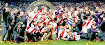  ??  ?? River Plate players celebrate with the trophy after winning the Copa Libertador­es final. — Reuters photo