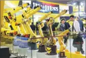  ?? GAO ERQIANG / CHINA DAILY ?? Fanuc Corp’s robotic arms draw the attention of visitors at a recent industrial exhibition in Shanghai.