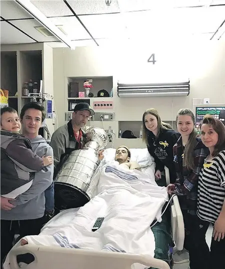  ??  ?? Ryan Straschnit­zki is joined by, from left, brothers Connor and Jett, father Tom, girlfriend Erica, sister Jaden and mother Michelle for a visit by the Stanley Cup at Saskatoon’s Royal University Hospital.