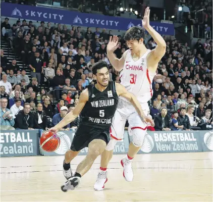  ?? PHOTO: GETTY IMAGES ?? Coming through . . . Tall Blacks point guard Shea Ili drives against China centre Wang Zhelin during their Fiba World Cup qualifying match in Auckland yesterday. The Tall Blacks won 6757.