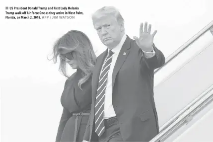  ??  ?? US President Donald Trump and First Lady Melania Trump walk off Air Force One as they arrive in West Palm, Florida, on March 2, 2018.