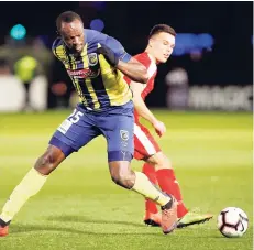  ??  ?? Usain Bolt (foreground) overruns the ball during a friendly trial match between the Central Coast Mariners and the Central Coast Select in Gosford, Australia, Friday, August 31, 2018. Bolt scored a brace yesterday in the Mariners latest friendly game.