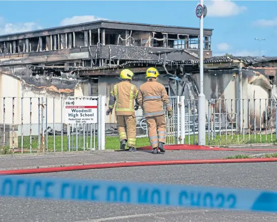  ?? Picture: PA. ?? Firefighte­rs at the scene after a ferocious blaze ravaged Woodmill High School.