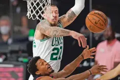  ?? MARK J. TERRILL/ASSOCIATED PRESS ?? The Celtics’ Daniel Theis blocks a shot by the Raptors’ Kyle Lowry during the first half of Saturday’s conference semifinal Saturday in Lake Buena Vista, Fla. Toronto won 100-93 to even the series at 2-2.