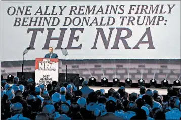  ?? CURTIS COMPTON/ATLANTA JOURNAL-CONSTITUTI­ON ?? Chris Cox of the NRA’s Institute for Legislativ­e Action helps introduce President Donald Trump last year in Atlanta.