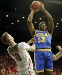  ?? RICK SCUTERI — THE ASSOCIATED PRESS ?? UCLA’s Ike Anigbogu (13) shoots over Markkanen Saturday in Tucson, Ariz. Arizona’s Lauri