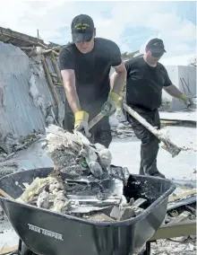  ?? THE CANADIAN PRESS ?? The crew of the HMCS St. John’s continues clean up operations at a school on South Caicos Island during Operation RENAISSANC­E, the hurricane Irma humanitari­an aid mission in the Caribbean earlier in September. The crew arrived Sunday in Dominica to...