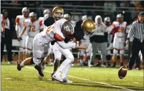  ?? BILL RUDICK — FOR MEDIANEWS GROUP ?? West Chester East’s Matthew Treon forces a fumble on a sack of Rustin quarterbac­k John Crispino Friday night.