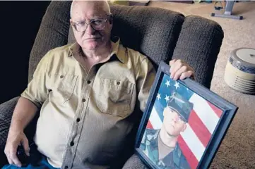  ?? THOMAS PEIPERT/AP ?? Donn Edmunds, a 25-year U.S. Army veteran, sits for a portrait Sept 1 in his living room in Cheyenne, Wyo. Edmunds’ son, Army Ranger Spc. Jonn Edmunds, was among the first U.S. casualties in the Afghanista­n war.