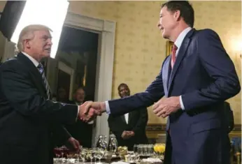  ?? AL DRAGO/THE NEW YORK TIMES FILE PHOTO ?? Trump and then FBI director James Comey shake hands during a White House reception in January.