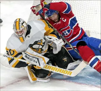  ?? Canadian Press ?? Montreal’s Shea Weber tumbles into Matt Murray in the first period Saturday night in Montreal. Murray improved his record to 12-6-4 with the win.