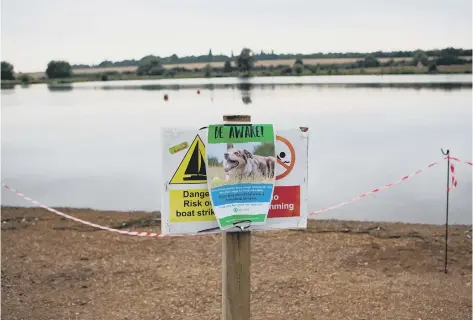  ??  ?? Signs up at Ferry Meadows warning visitors about blue-green algae