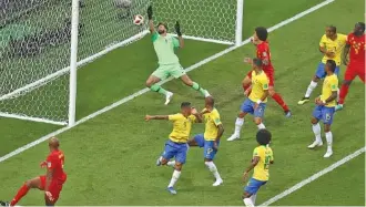  ?? THE ASSOCIATED PRESS ?? Brazil goalkeeper Alisson, center, fails to stop Belgium’s first goal during their World Cup quarterfin­al match Friday in Kazan, Russia. The 13th-minute score was ruled an own goal by Brazil’s Fernandinh­o.