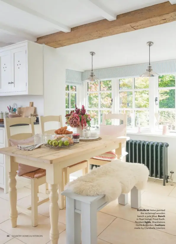  ??  ?? Kitchen Helen painted the reclaimed wooden bench a pale blue. Bench in Pearl Ashes, Fired Earth. Pendant lights, Shackleton­s Home & Garden. Cushions made by Clarabelle Interiors