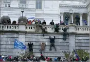  ?? JOSE LUIS MAGANA — THE ASSOCIATED PRESS ?? Supporters of President Donald Trump climb the west wall of the the U.S. Capitol on Wednesday.