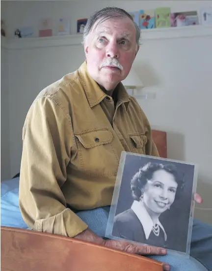  ?? TONY CALDWELL ?? Jeff Marier holds a photo of his mother Mary while visiting her at her long-term-care facility in Ottawa last month. Mary has Alzheimer’s disease and needs constant monitoring to prevent her from wandering.