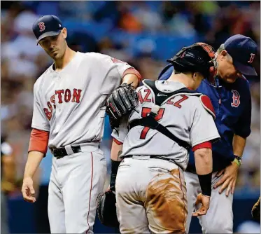  ?? [CHRIS O’MEARA/THE ASSOCIATED PRESS] ?? Boston Red Sox starting pitcher Rick Porcello, left, pats catcher Christian Vazquez on the back after being taken out of the baseball game by manager John Farrell, right, during the eighth inning against the Tampa Bay Rays on Saturday in St....