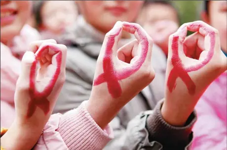  ??  ?? Students show their hands painted to look like red ribbons during a world AIDS Day event at a school in Hanshan, central China’s Anhui province on Nov 30, one day before the 2012 AIDS Day. Chinese AIDS activists on Nov 29 accused the Communist Party’s...