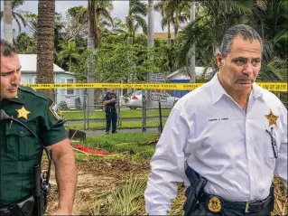  ?? ALEXANDRA SELTZER / THE PALM BEACH POST ?? Palm Beach County Sheriff’s Office Capt. Jeffrey Calise (right) walks away from the scene Thursday after a shooting at Inlet Harbor Club, a condo complex in Boynton Beach. Authoritie­s did not say when they would identify a deputy who killed himself or a woman who was shot.