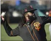  ?? ROSS D. FRANKLIN — THE ASSOCIATED PRESS ?? Giants pitcher Johnny Cueto warms up during spring training on Wednesday in Scottsdale, Ariz.