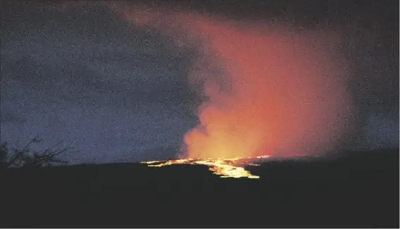  ?? CHELSEA JENSEN/WEST HAWAII TODAY VIA AP ?? Lava pours out of the summit crater of Mauna Loa about 6:35 a.m. Monday as seen from Gilbert Kahele Recreation Area on Maunakea, Hawaii.