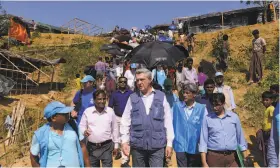  ?? Ziaul Haque Oisharjh / Associated Press ?? United Nations High Commission­er for Refugees Filippo Grandi (center) visits Rohingya Muslims at the Kutupalong refugee camp in Cox’s Bazar, Bangladesh.