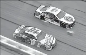  ?? AP/PAUL ABELL ?? Drivers Kyle Busch (18) and Kevin Harvick (4) race down the front stretch during the NASCAR Monster Energy Cup Series race Sunday at Atlanta Motor Speedway in Hampton, Ga. Harvick won the race and Busch finished seventh.