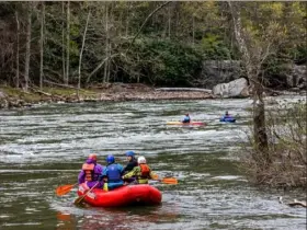  ?? Andrew Rush/Post-Gazette ?? GO WITH THE FLOW Rafters and kayakers make their way down the Youghioghe­ny River in Ohiopyle State Park on Tuesday in Ohiopyle.