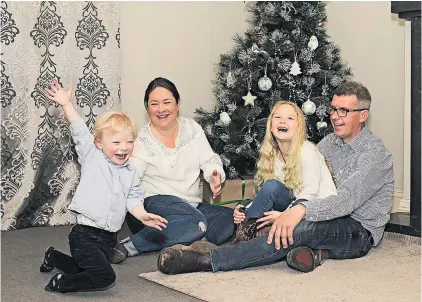  ??  ?? Luke Drummond, 3, with his parents Hannah and Craig Drummond and sister Briar, 6. The family spent last Christmas at Starship children’s hospital.