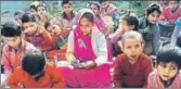  ?? MAHIPAL SINGH / HT PHOTO ?? ■ Ramwati (centre) studies with students at the Qazimabad primary school in Atrauli, Aligarh.