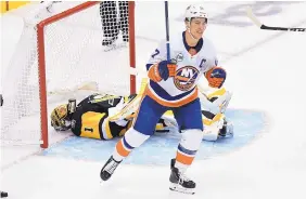  ?? DON WRIGHT/ASSOCIATED PRESS ?? Islanders right wing Jordan Eberle (7) celebrates his third-period goal in New York’s win over Pittsburgh on Tuesday night. Penguins goalie Casey DeSmith is at rear.