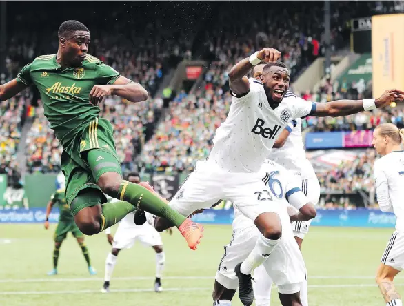  ?? JAIME VALDEZ/USA TODAY ?? Portland Timbers defender Larrys Mabiala and Whitecaps forward Bernie Ibini cross paths going for the ball during a corner kick at Providence Park Sunday.
