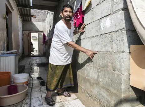  ?? Pictures: Antonie Robertson / The National ?? Mushtaq Mohammed-Baksh and his family sheltered in a school after flash-flooding across Fujairah. Mr Mohammed-Baksh, who points to the high water line left on the wall of his house, praises his neighbours for their help
