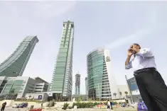  ??  ?? A person is seen standing at the junction of Bahrain Financial Harbour in Manama. — Reuters photo