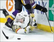  ?? Jeff Roberson ?? Golden Knights forward Tomas Nosek watches the puck slip away while pinned to the ice by St. Louis’ Robert Thomas (18).The Associated Press